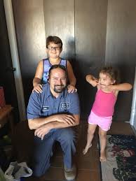 Man with children smiling in a home entryway