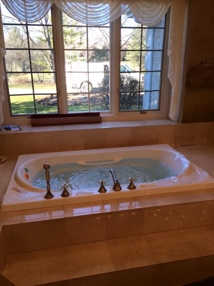 Elegant bathtub with jets in a well-lit bathroom